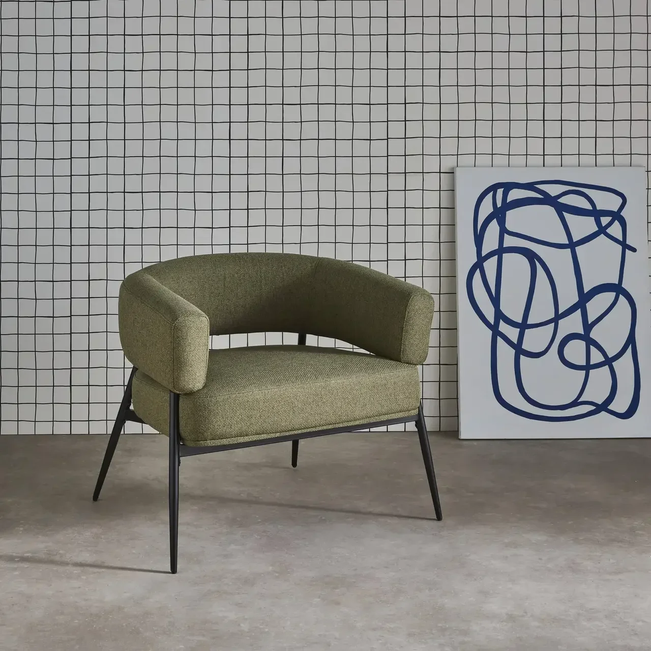 Fauteuil design Cristo tissu dossier incurvé piétement métal salon cosy
